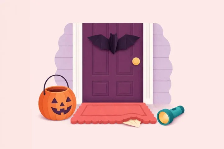 Halloween scavenger hunt clue card under a doormat next to a pumpkin candy bucket and a flashlight