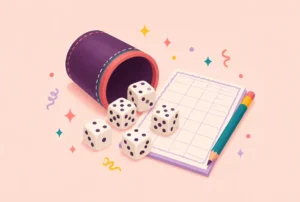 Five dice tumbling out of a dice cup next to a score sheet and pencil