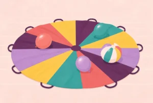 A rainbow play parachute on a gym floor with balloons and a beach ball